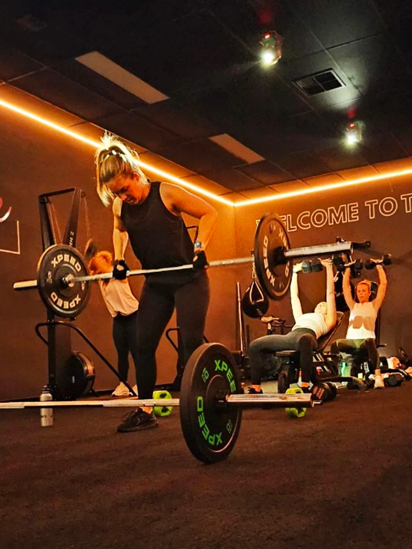 woman lifting weights in the hustle room
