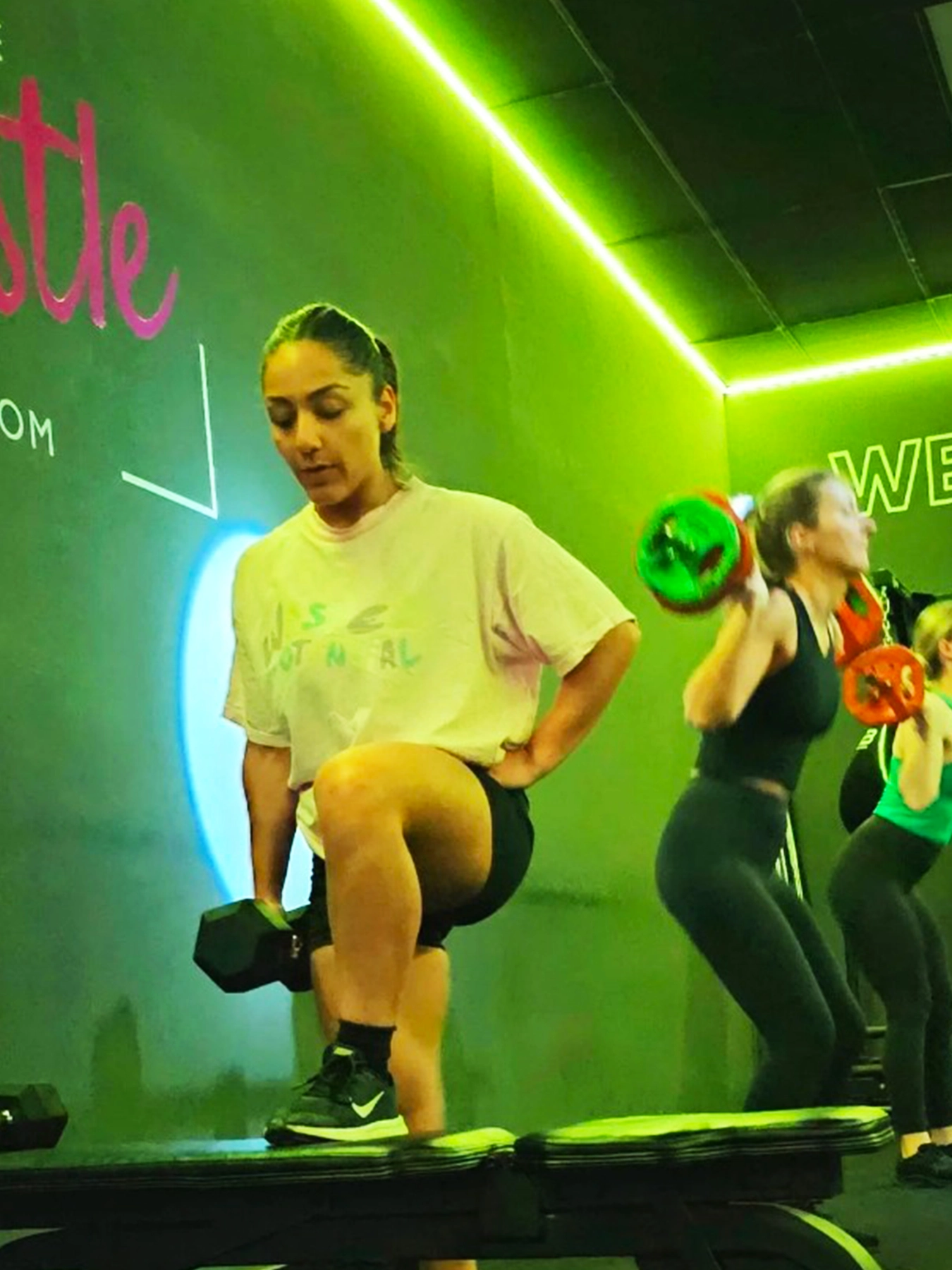 women lifting weights at the gym