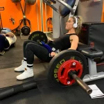woman lifting weights at the gym